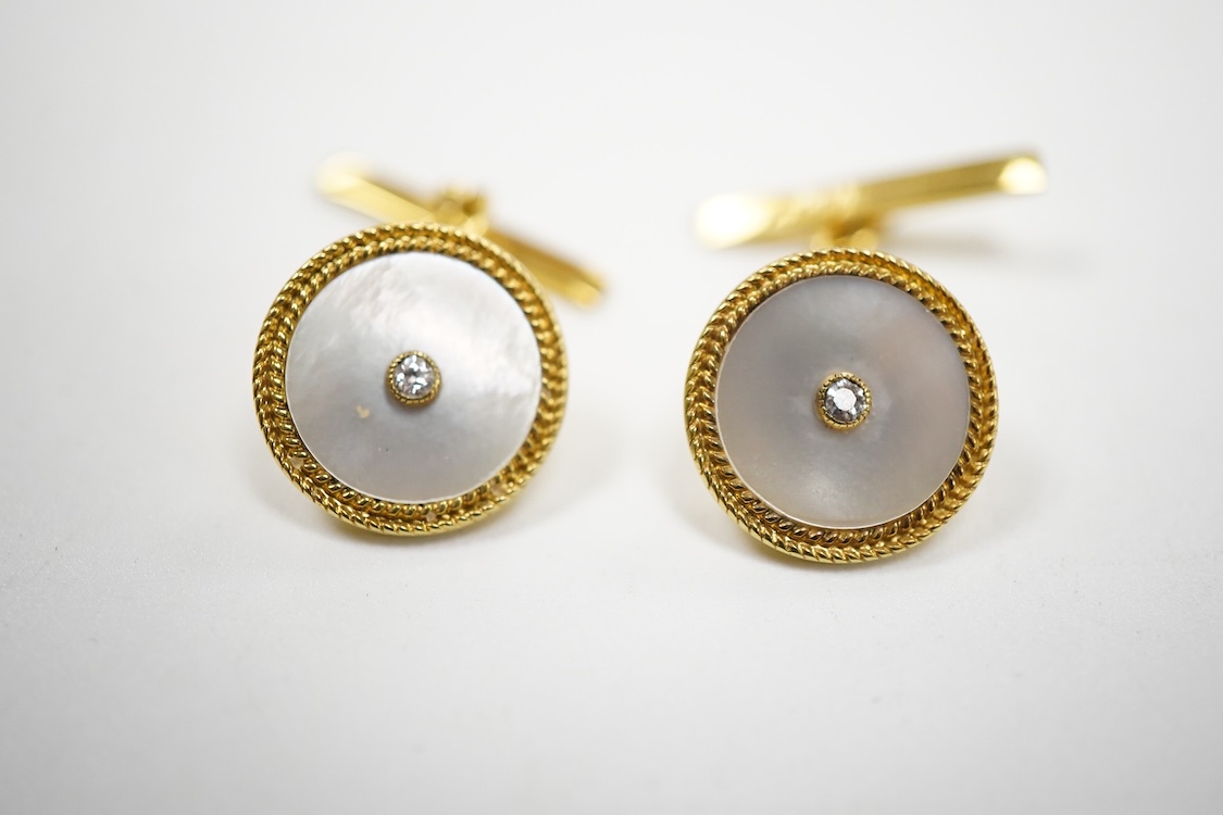 A pair of yellow metal (stamped 18) mounted, mother of pearl and diamond set disc cufflinks, diameter 12mm, gross weight 5.2 grams.